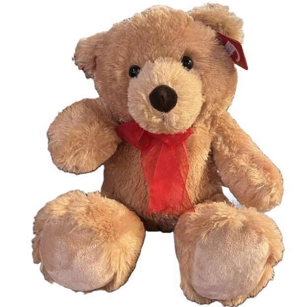 Soft brown teddy bear with a red ribbon around its neck, sitting upright and facing forward