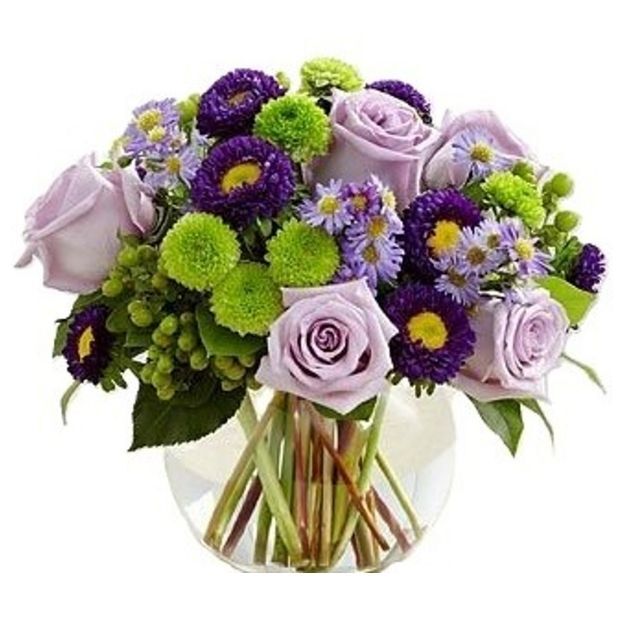 Colorful bouquet of lavender, purple, and green flowers arranged in a clear round vase, showcasing fresh floral variety.