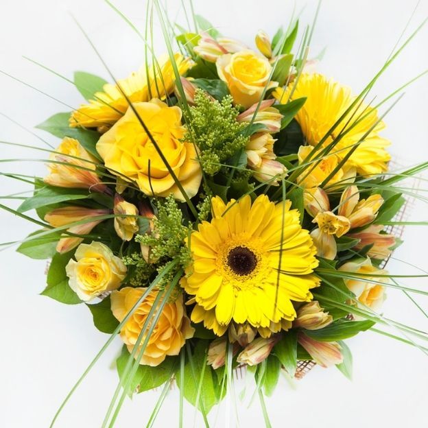 Cheerful yellow mix of gerberas, roses, and alstroemeria, accented with airy grasses and fresh greenery.